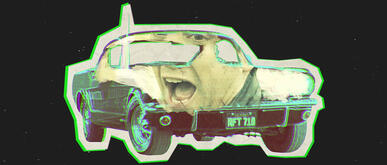 Ralph Macchio screams inside a car.